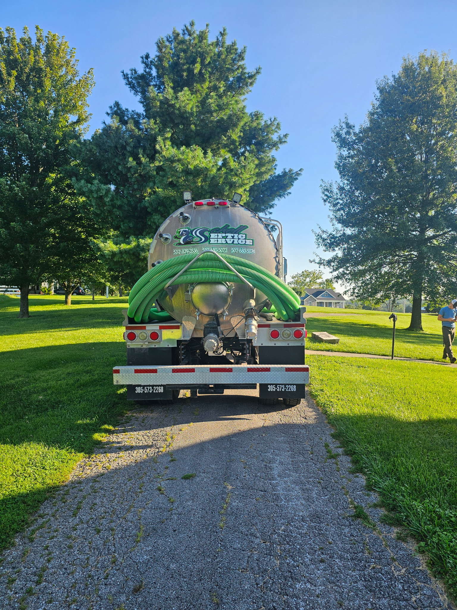 Schell Septic Service technicians servicing a septic tank in Lawrenceburg area